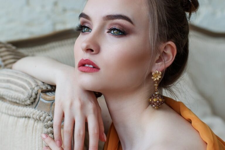 a model giving a pose for photo shoot showing coordination between jewellery with makeup