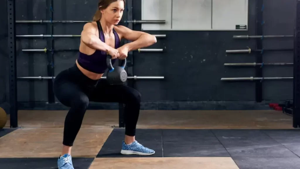 Woman doing exercise with dumbell