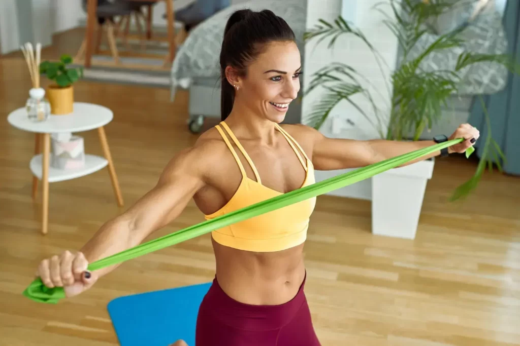 woman exercising with resistance band at home